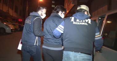 Counterterrorism police escort a captured suspect in an operation against FETÖ, in Istanbul, Turkey, March 31, 2021. (İHA PHOTO)