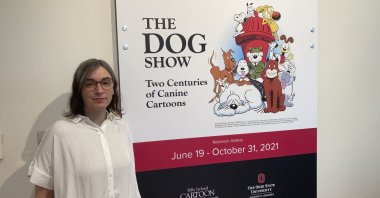 Anne Drozd, museum coordinator at The Ohio State University's Billy Ireland Cartoon Library Museum, stands at the entrance to the library's new exhibit, "The Dog Show," Columbus, Ohio, U.S., June 24, 2021. (AP Photo)