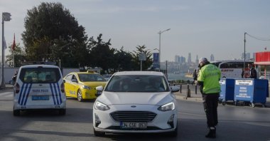 A traffic police checks a car in Üsküdar, Istanbul, Turkey, April 29, 2021. 