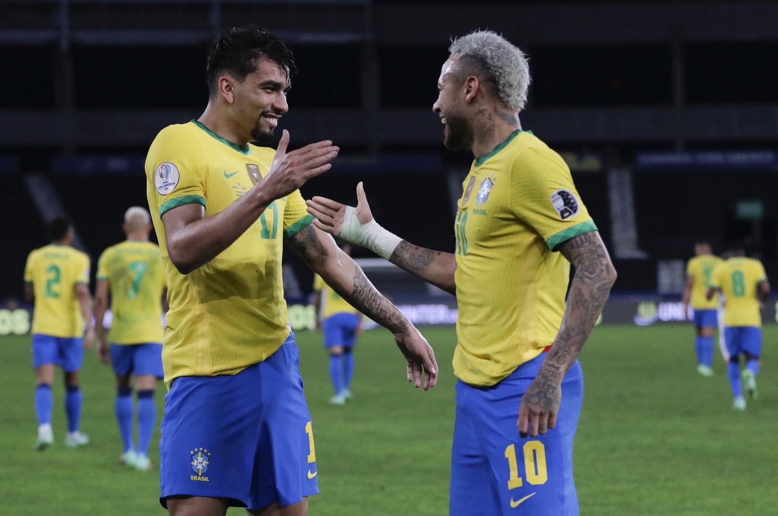 Brazil's Lucas Paqueta (L) celebrates with teammate Neymar after scoring his side's opening goal in the Copa America semifinal against Peru at Nilton Santos stadium in Rio de Janeiro, Brazil, July 5, 2021. (AP Photo)