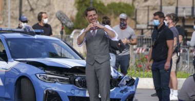 Tom Cruise makes the sign of a heart towards fans during a break in the shooting of the film "Mission Impossible 7," in Rome, Italy, Oct. 12, 2020. (AP Photo)