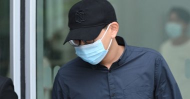 Derek Ng De Ren leaves the state court in Singapore after being sentenced to nine months probation and 40 hours of community service for sending death threats to English Premier League footballer Neal Maupay and his family, July 7, 2021. (AFP Photo)