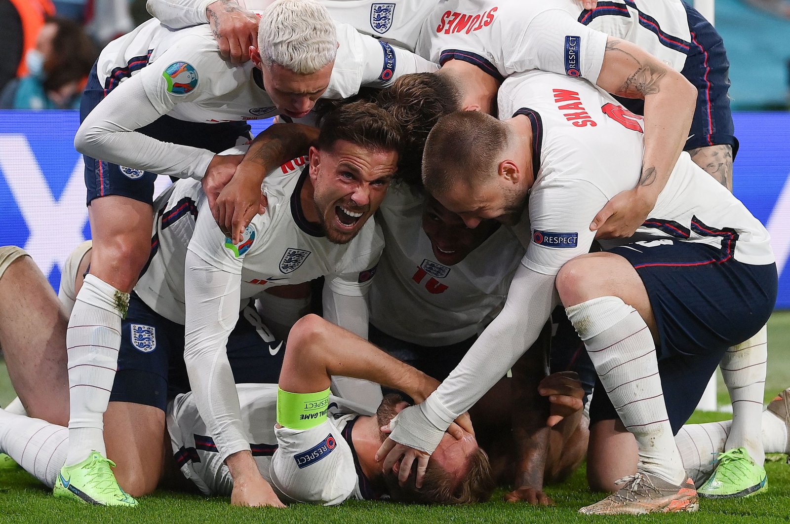 England's forward Harry Kane (bottom) celebrates with teammates after scoring a goal during the UEFA EURO 2020 semifinal football match between England and Denmark at Wembley Stadium in London, July 7, 2021. (AFP Photo)