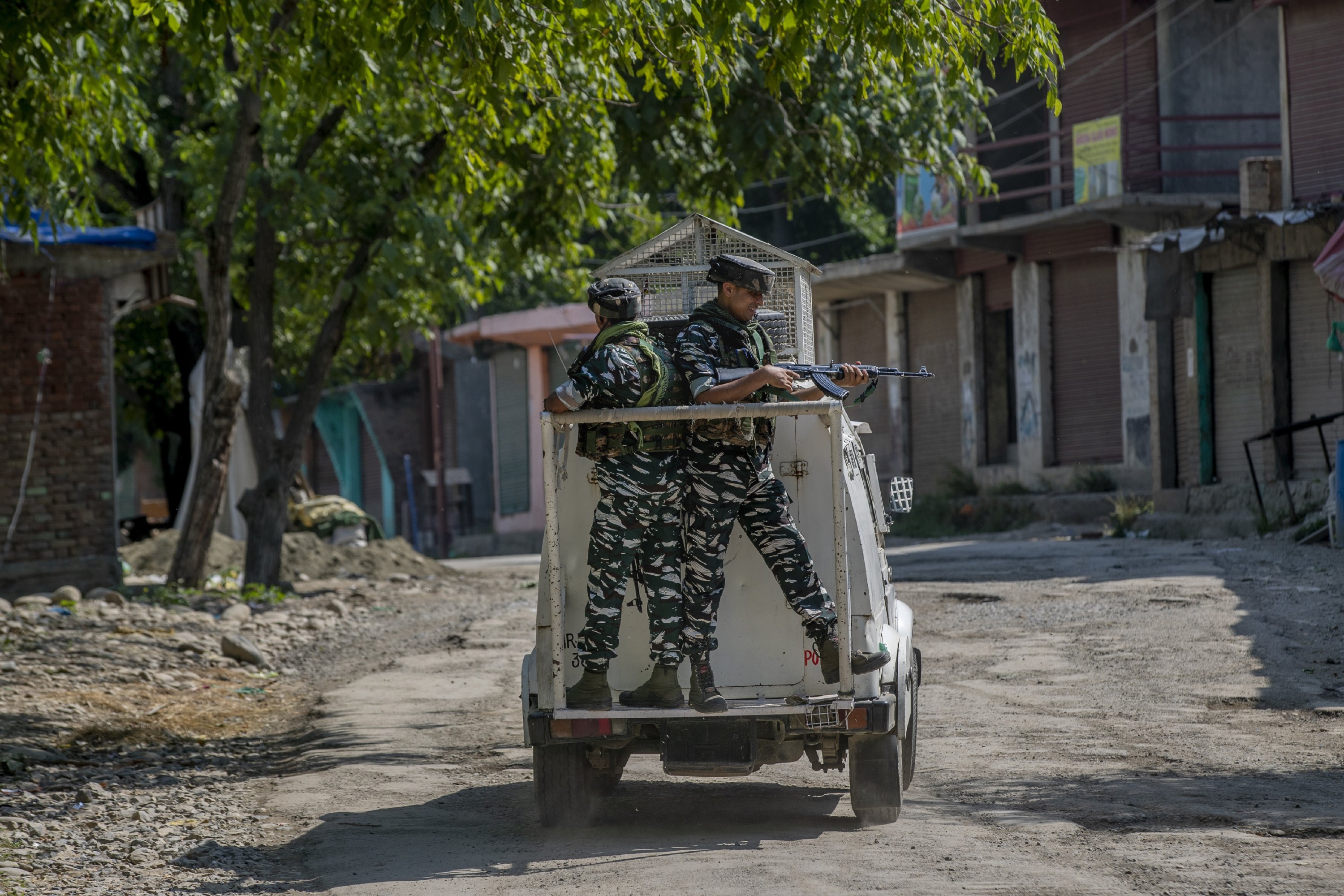 Indian paramilitary soldiers stand guard on an armored vehicle as they move toward the site of a gunfight in Pulwama, south of Srinagar, Indian-controlled Kashmir, July 2, 2021. (AP Photo)