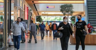 People wearing protective masks walk inside a shopping mall in Antalya, southern Turkey, May 13, 2020. (DHA Photo)