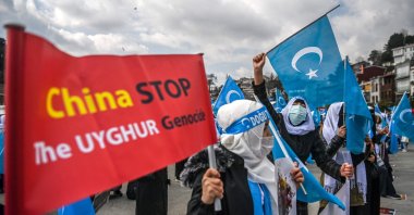 Women from the Muslim Uyghur minority hold placards and flags of East Turkestan as they demonstrate near the Chinese Consulate in Istanbul, Turkey, March 8, 2021. (AFP File Photo)
