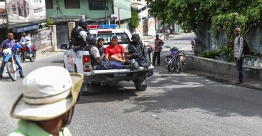 Two men accused of being involved in the assassination of Haiti President Jovenel Moise are being transported to the Petionville station in a police car in Port-au-Prince, Haiti, July 8, 2021. (AFP Photo)