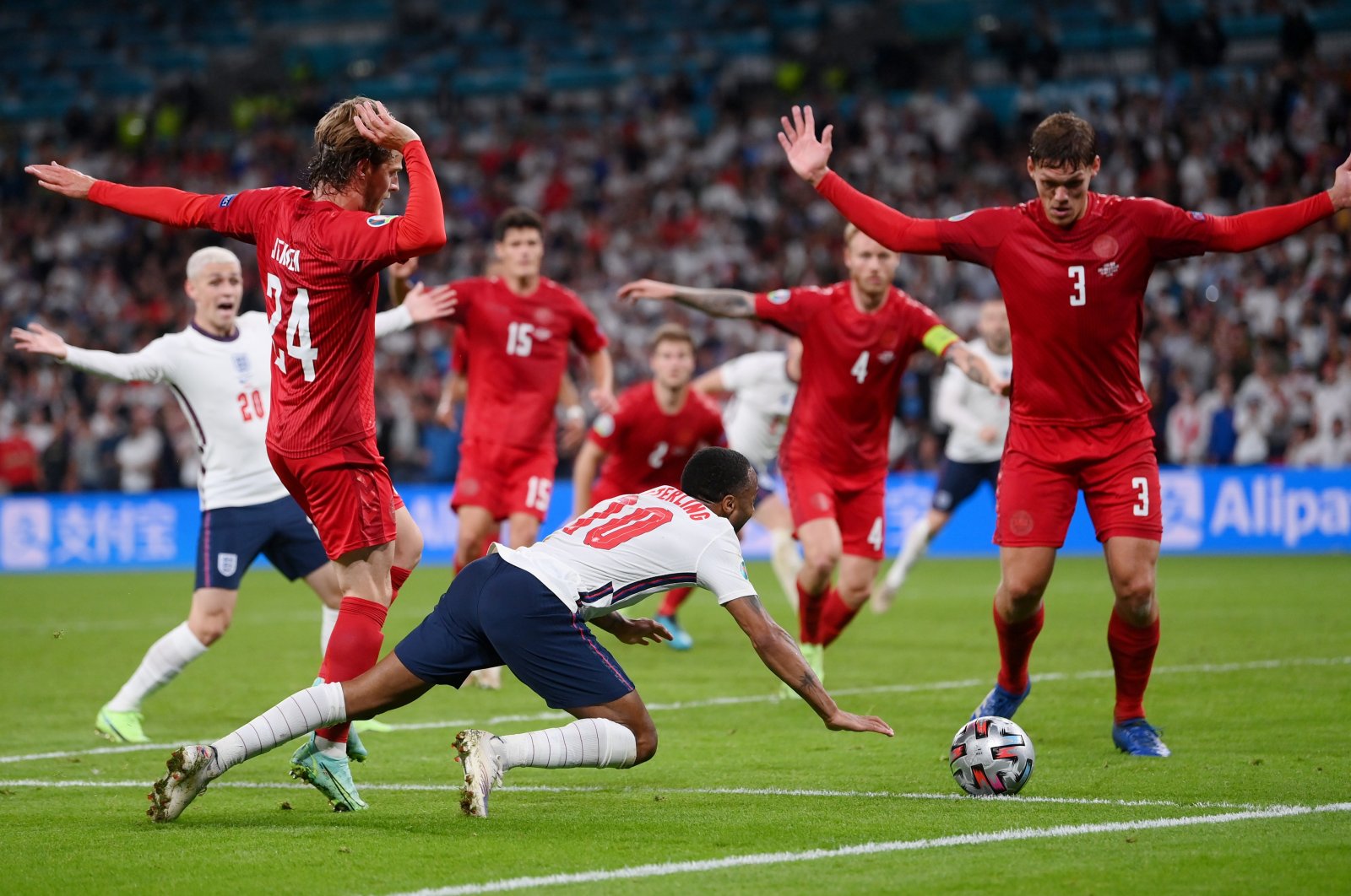 England's Raheem Sterling (C) goes down inside the Denmark penalty box for a penalty during the Euro 2020 semifinal at the Wembley Stadium, London, Britain, July 7, 2021. (Reuters Photo)