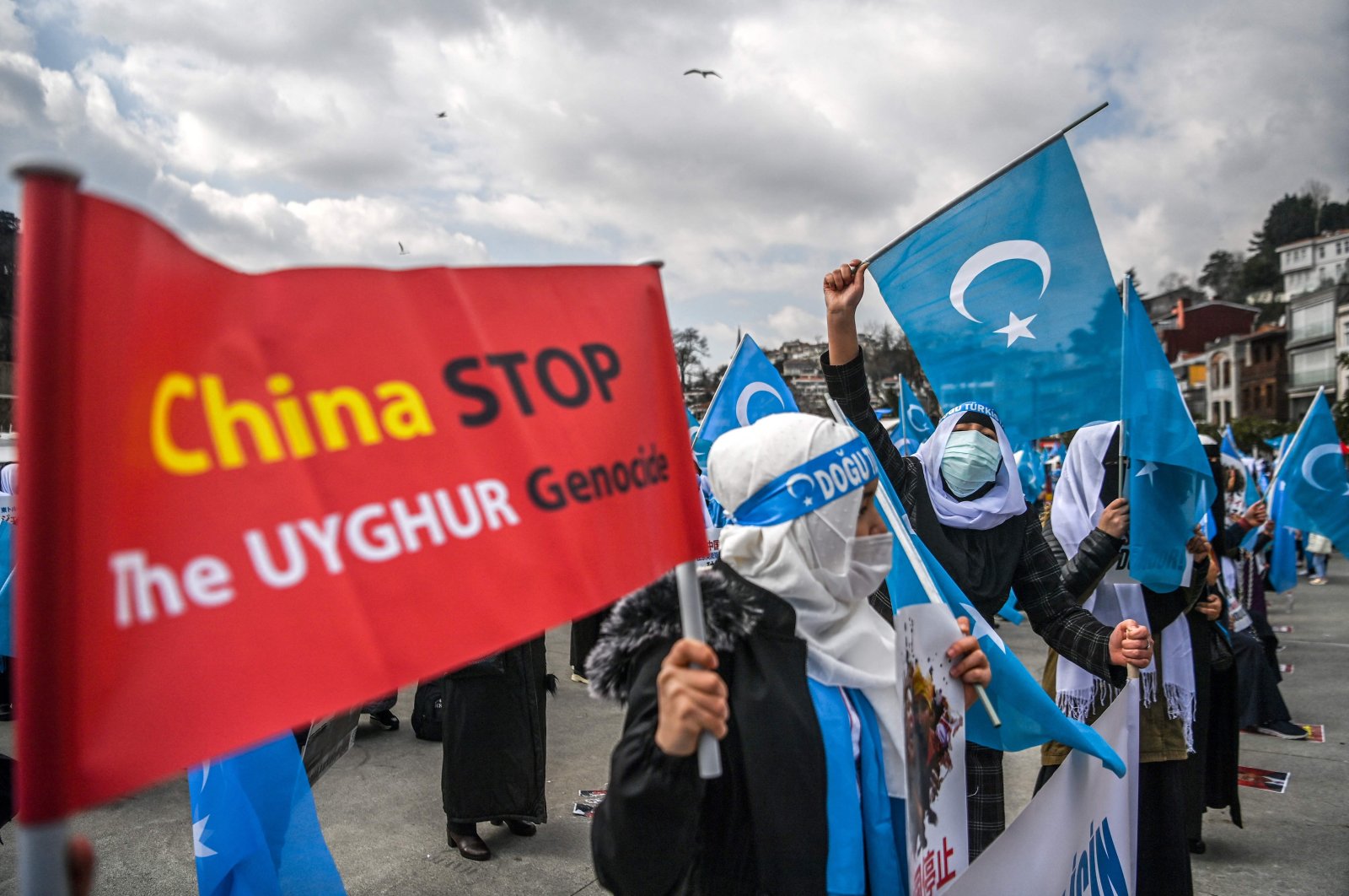 Women from the Muslim Uyghur minority hold placards and flags of East Turkestan as they demonstrate near the Chinese Consulate in Istanbul, Turkey, March 8, 2021. (AFP File Photo)