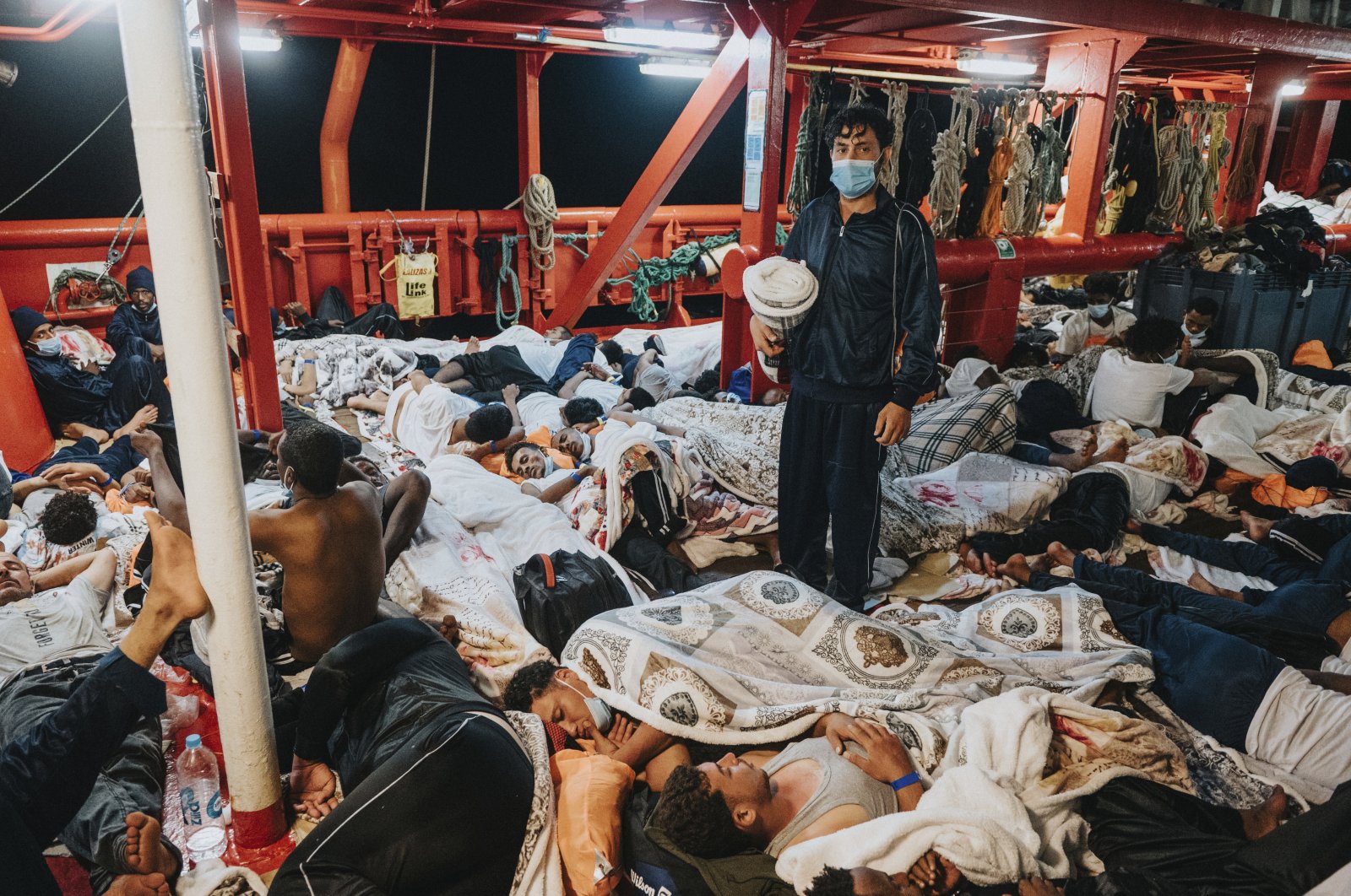 Rescued migrants sleep on the deck of the Ocean Viking rescue ship in the Mediterranean Sea, July 8, 2021. (AP Photo)