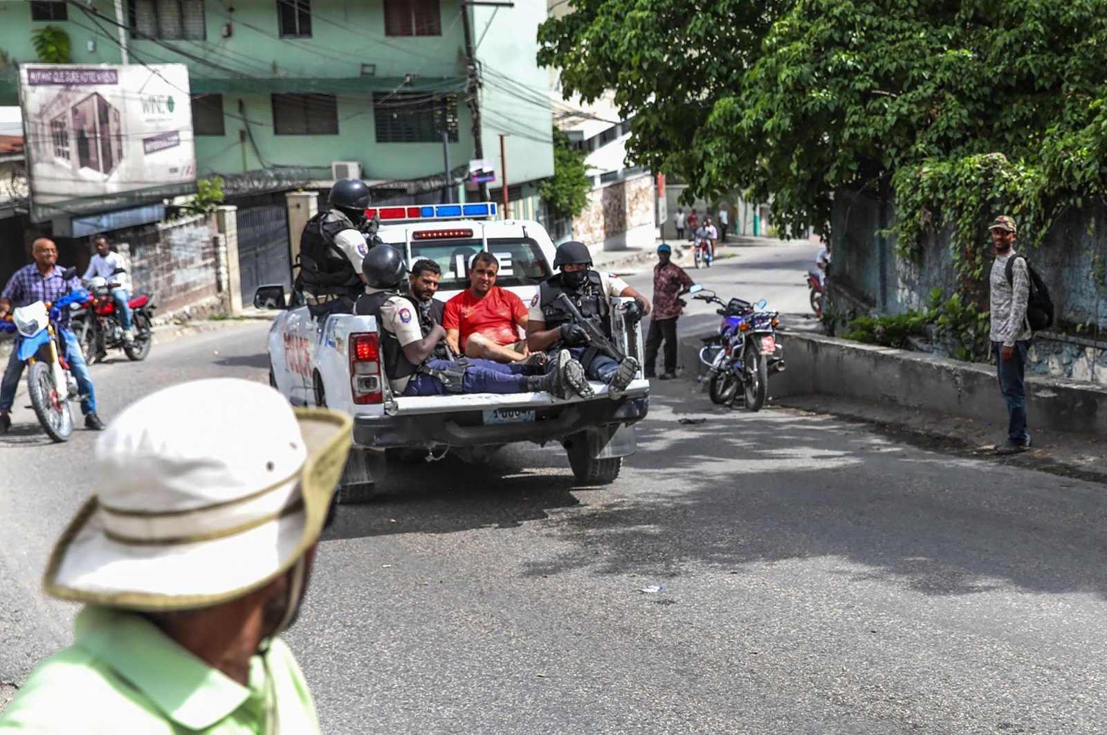 Two men accused of being involved in the assassination of Haiti President Jovenel Moise are being transported to the Petionville station in a police car in Port-au-Prince, Haiti, July 8, 2021. (AFP Photo)