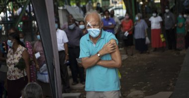 An elderly Sri Lankan holds his arm after receiving a dose of Pfizer COVID-19 vaccine at a vaccination site in Colombo, Sri Lanka, Wednesday, July 7, 2021. 
(AP Photo)