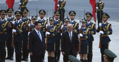 Afghan President Ashraf Ghani Ahmadzai, center right, and Chinese President Xi Jinping, center left, review a guard of honor during a welcome ceremony outside the Great Hall of the People in Beijing, China, Oct. 28, 2014. (AP Photo)