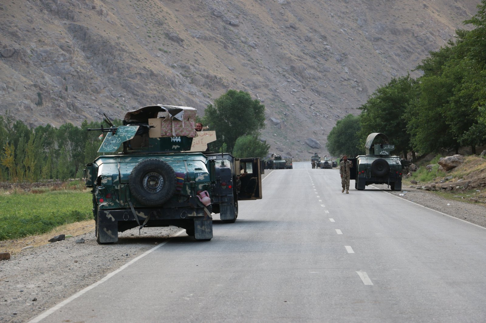 Afghan soldiers pause on a road at the front line of fighting between Taliban and Security forces, near the city of Badakhshan, northern Afghanistan, July. 4, 2021. (AP Photo)