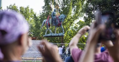 Workers remove the statue of Confederate General Robert E. Lee in Market Street Park in Charlottesville, Virginia, USA, July 10, 2021. (EPA Photo)