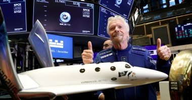 Sir Richard Branson poses on the floor of the New York Stock Exchange (NYSE) ahead of Virgin Galactic (SPCE) trading in New York, U.S., Oct. 28, 2019. (Reuters Photo)