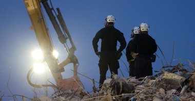 Search and rescue workers oversee an excavator dig through the rubble of the collapsed 12-story Champlain Towers South condo building on July 9, 2021 in Surfside, Florida. (Anna Moneymaker/Getty Images/AFP)