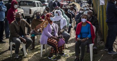 Ethiopians queue on chairs in the street as they wait to cast their votes in the general election at a polling center in the capital Addis Ababa, Ethiopia, Monday, June 21, 2021. (AP Photo)