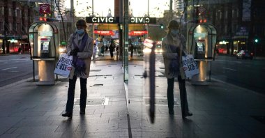A woman wearing a protective face mask walks through the city center during a lockdown to curb the spread of a coronavirus outbreak in Sydney, Australia, July 7, 2021. (Reuters Photo)