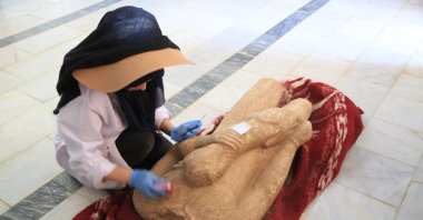 An archaeologist restores a statue unearthed during excavations in the ancient city of Euromos, Muğla, Turkey, July 11, 2021. (AA Photo)