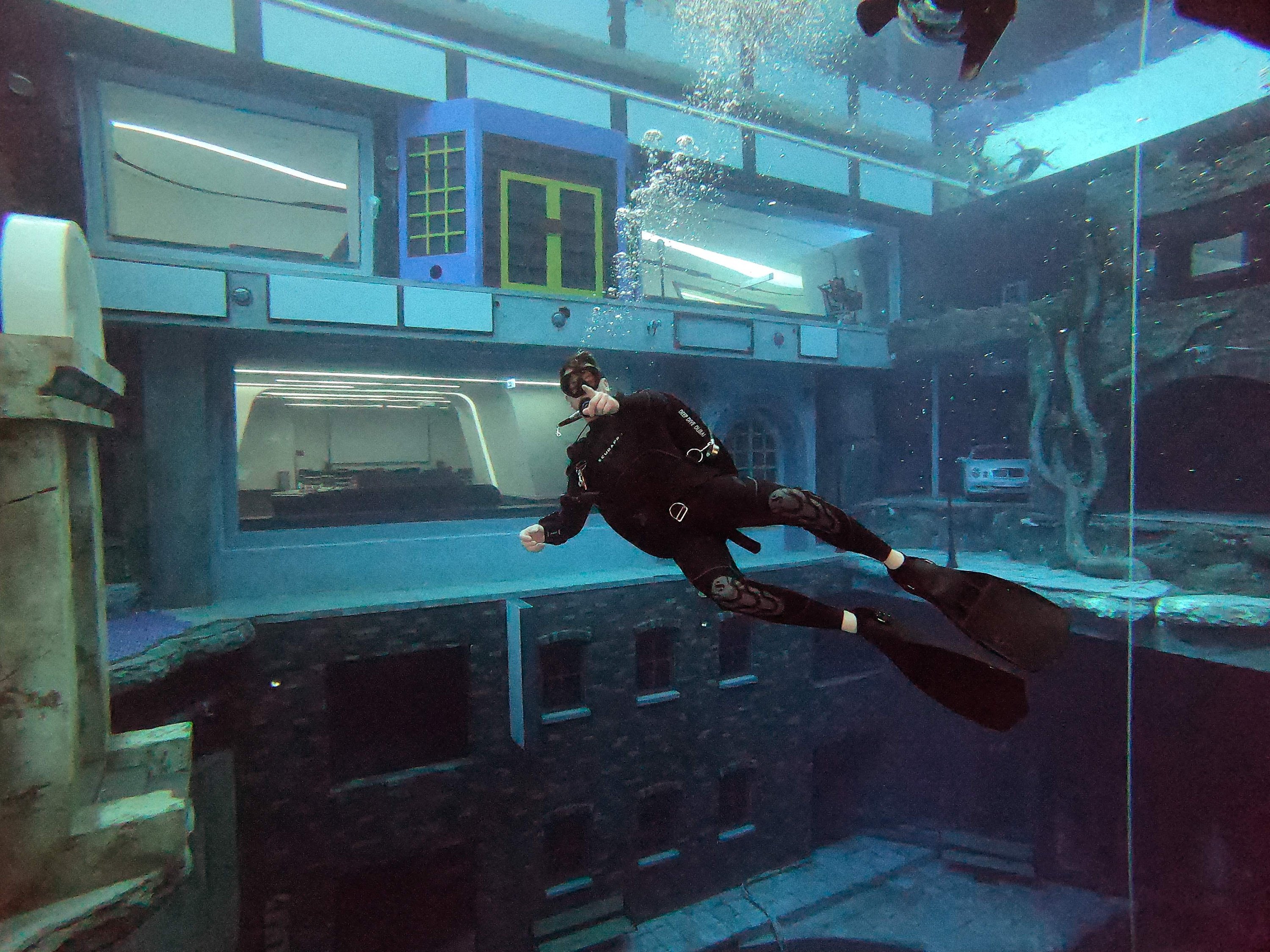 A diver explores a mock sunken city as he experiences Deep Dive Dubai, the deepest swimming pool in the world reaching 60 meters (nearly 200 feet), in the United Arab Emirates, July 10, 2021. (AFP Photo)