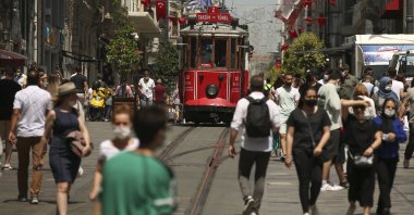 People walk on Istiklal Avenue, the main shopping street in Istanbul, Turkey, July 1, 2021. (AP Photo)