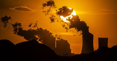 The sun sets behind the coal-fired Boxberg Power Station and the Reichwalde coal mine, seen from the vantage point of Hammerstadt, Germany, on April 9, 2020. (Getty Images)