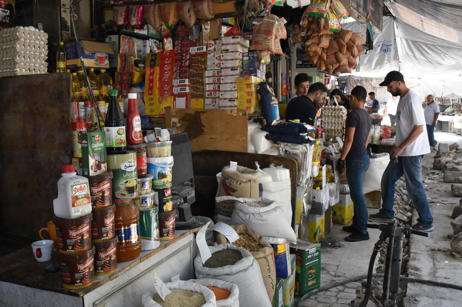 Syrians shop at a market in Damascus hours after Syrian regime leader Bashar Assad issued a legislative decree granting civil servants and military members a 50% salary increase, Damascus, Syria, July 11, 2021. (EPA Photo)