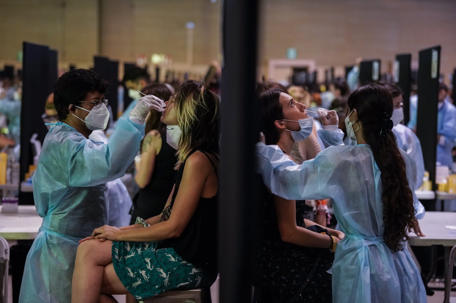 Health workers take swab samples for a COVID-19 antigen test ahead of the Cruilla music festival in Barcelona, Spain, July 9, 2021. (AP Photo)