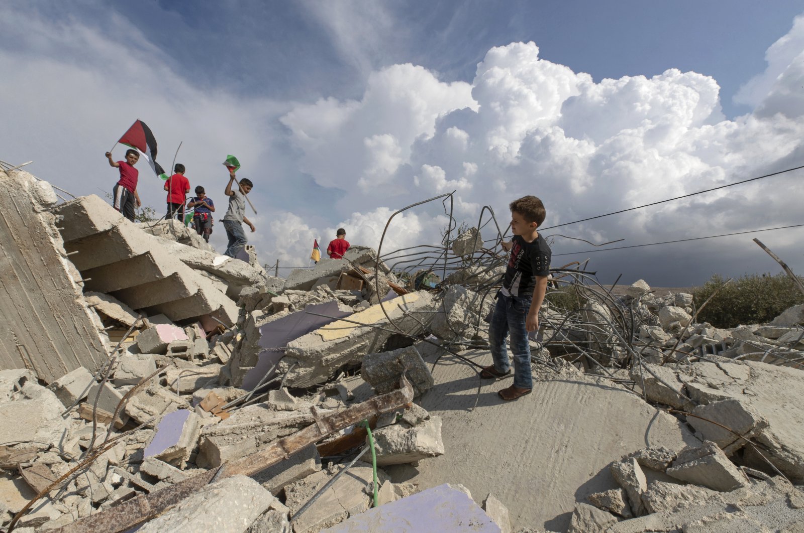 Palestinian children play on top of the demolished house of Khalil Dweikat, in the occupied West Bank village of Rojeeb, Palestine, Nov. 2, 2020. (AP File Photo/Nasser Nasser)