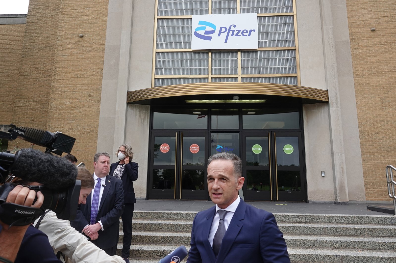 Germany's Foreign Minister Heiko Maas stands in front of the production facility of the US pharmaceutical company Pfizer in Kalamazoo, July 13, 2021. (DPA via Reuters)