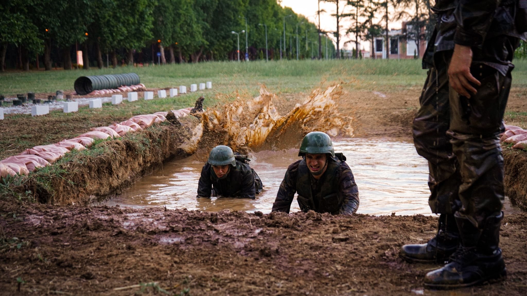 Actors struggle through a training course in a military complex, in a scene from the documentary series "Mahrem." (AA)