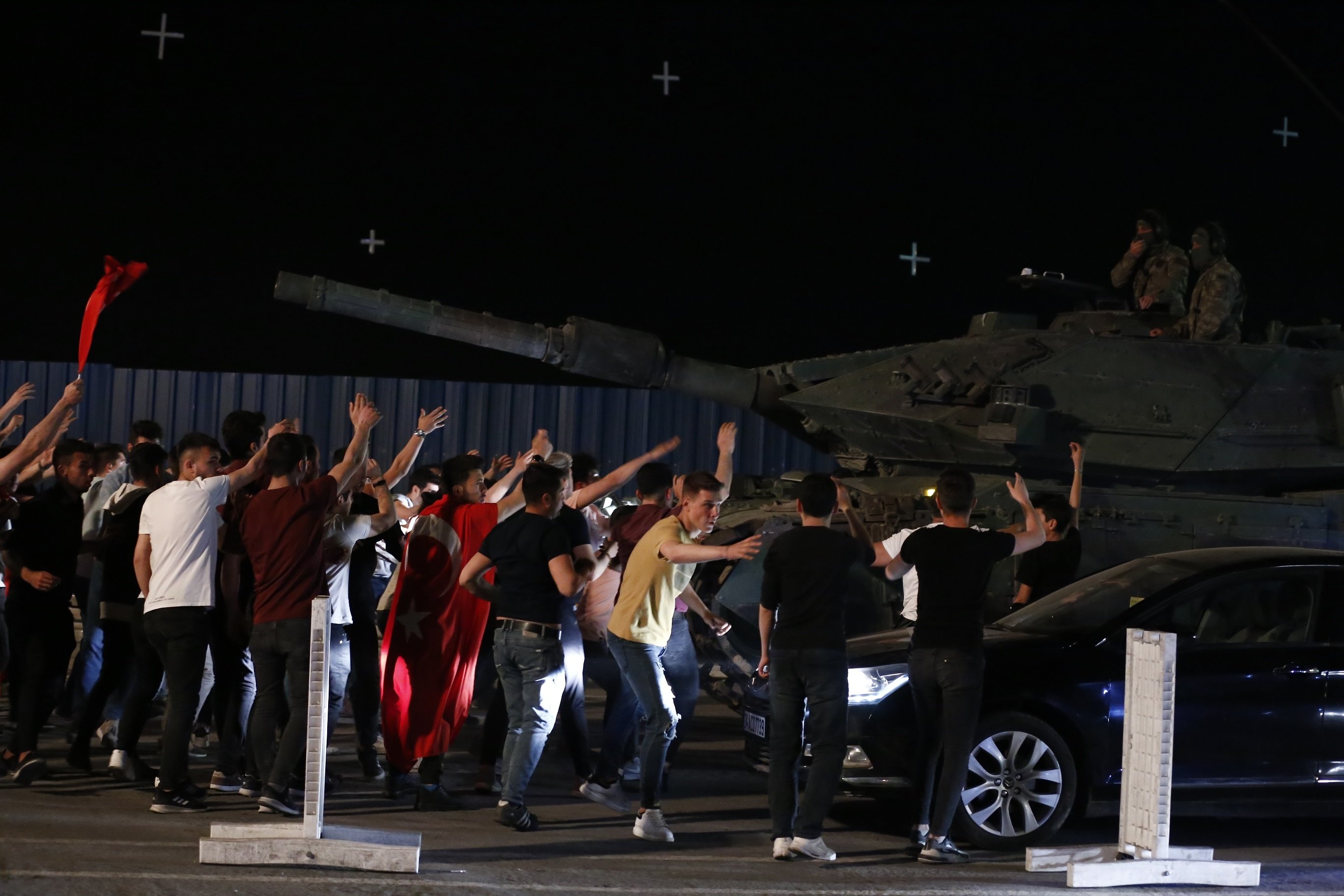 Actors swarm around a military tank in a scene from "15/07: Şafak Vakti."