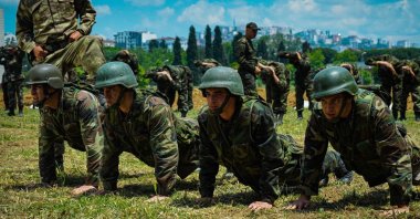 Actors do push ups in a training course in a military complex, in a scene from the documentary series "Mahrem." (AA)