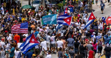 People march in the streets and wave Cuban flags during a protest in solidarity with thousands of Cubans who took to the streets in various locations in Cuba, in one of the largest protests to take place on the island, at Versailles Cuban restaurant off 8th Street in the Little Havana neighborhood of Miami, U.S., July 11, 2021. (AP Photo)