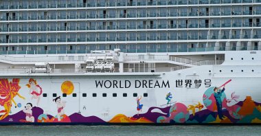 People are seen on board the Dream Cruises' World Dream cruise ship after it returned to the city-state following a passenger testing positive for the coronavirus, the Marina Bay Cruise Centre Singapore, Singapore, July 14, 2021. (AFP Photo)