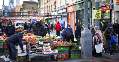 People shop at a market stall in east London, Britain, Jan. 23, 2021. (Reuters Photo)