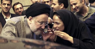 Outgoing reformist Iranian President Mohammad Khatami talks on the phone with the mother of female journalist Masih Alinejad, right, after meeting with journalists in Tehran, Iran, July 13, 2005. (AP Photo)