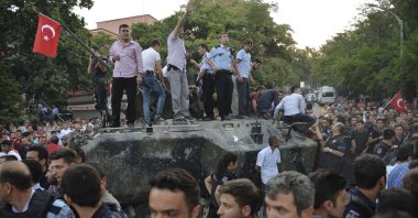 People gather and some stand atop a Turkish army armored vehicle during the attempted coup in Ankara, Turkey, July 16, 2016. (AP Photo)