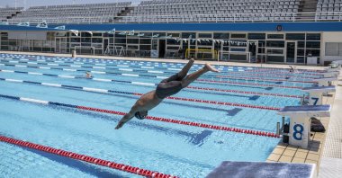 Syrian refugee Ibrahim al-Hussein, an amputee swimmer who lost his leg during the war in Syria, dives during training at the Olympic Aquatic Center, Athens, Greece, June 30, 2021. (AP Photo)