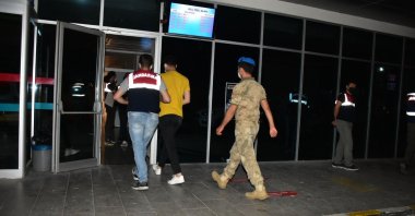 Gendarmerie officers escort a FETÖ suspect, in Izmir, western Turkey, July 12, 2021. (DHA PHOTO) 