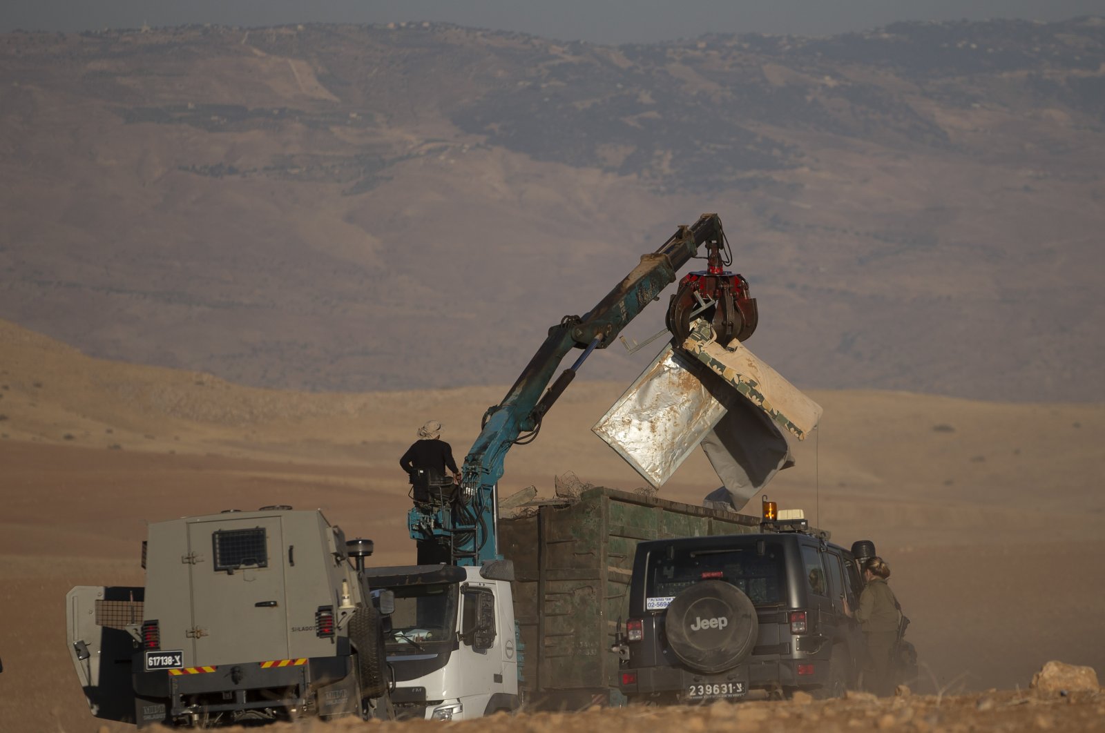 Israeli forces demolish tents and other structures belonging to Bedouins at the Khirbet Humsu hamlet in Jordan Valley in the West Bank, Wednesday, July 7, 2021. (AP Photo)