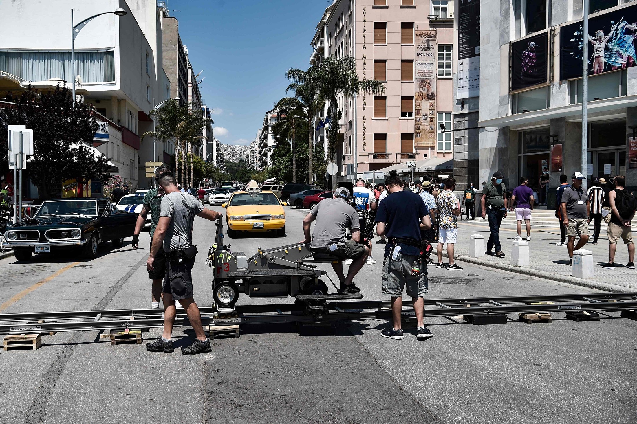 Film crew members work during the filming of the action thriller, "The Enforcer," starring Spanish actor, film director and producer Antonio Banderas, in a street of Thessaloniki, Greece, July 3, 2021. (AFP Photo)