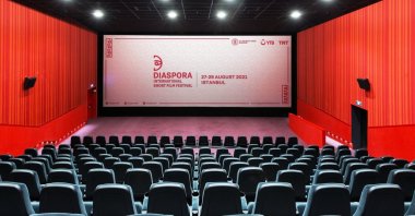 A panoramic view of an empty movie theater with a screen. (Shutterstock Photo)