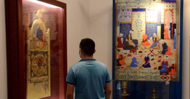 A visitor examines works in the Çifte Minareli Medrese, Erzurum, eastern Turkey, July 15, 2021. (DHA Photo)