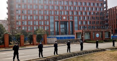 Security personnel keep watch outside the Wuhan Institute of Virology during the visit by the World Health Organization (WHO) team tasked with investigating the origins of the coronavirus, in Wuhan, Hubei province, China, Feb. 3, 2021. (Reuters Photo)