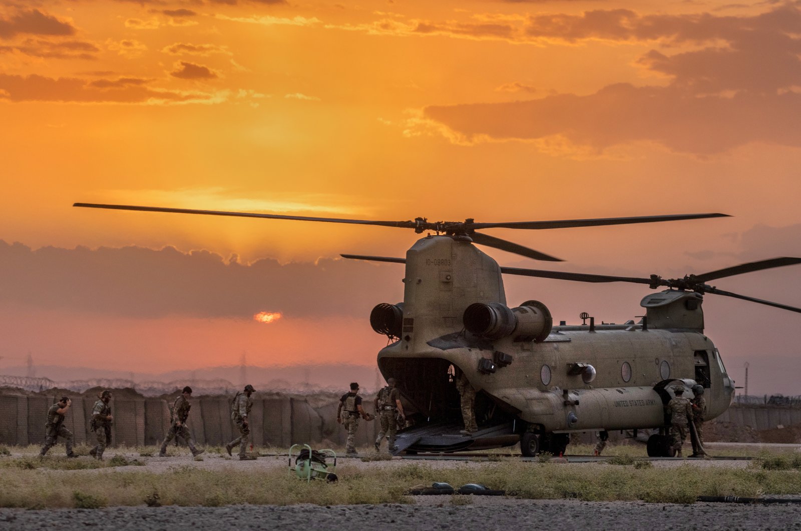 U.S. Army soldiers board a CH-47 Chinook helicopter while departing a remote combat outpost known as RLZ  near the Turkish border in northeastern Syria, May 25, 2021. (Getty Images)