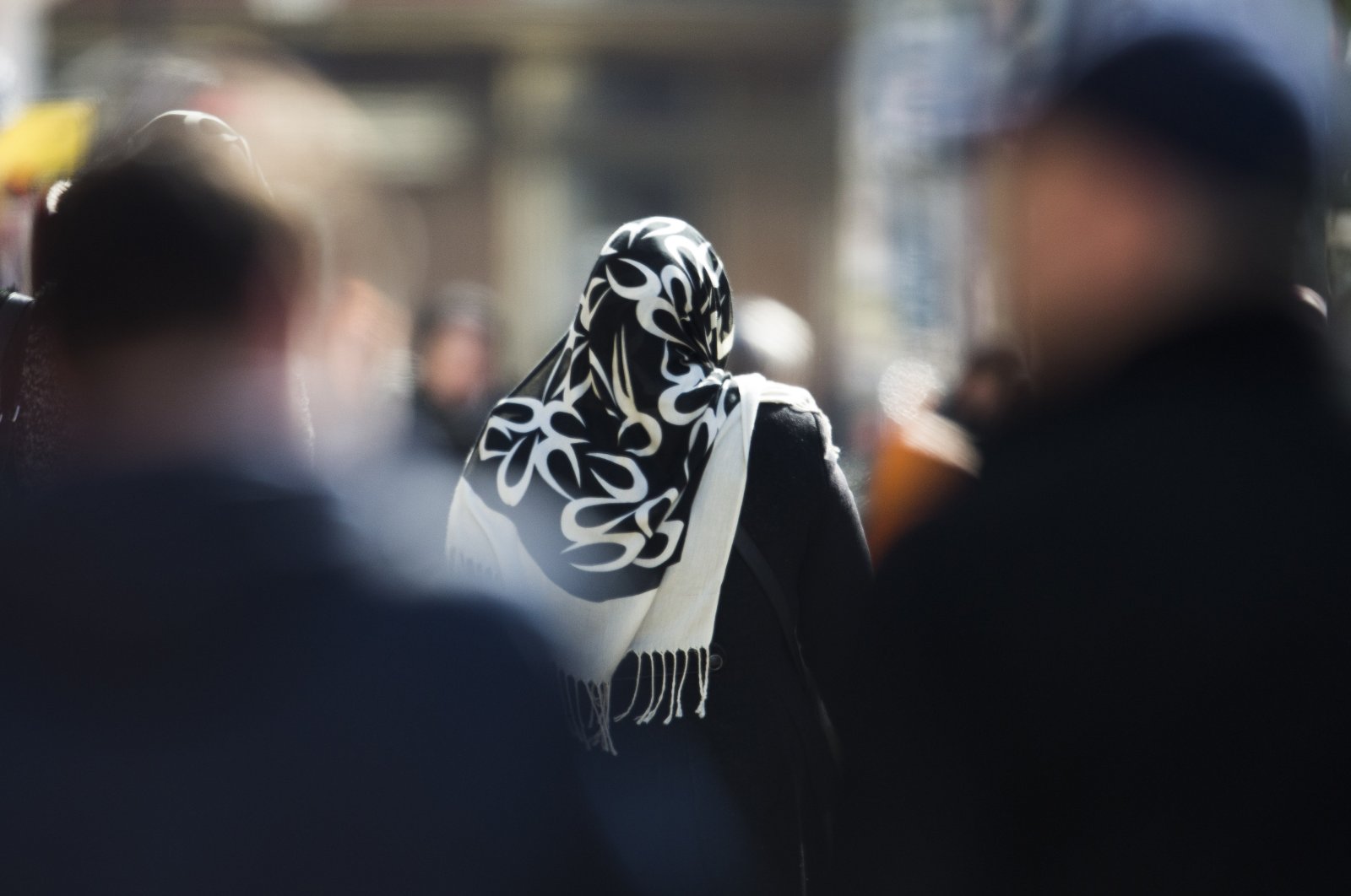 A woman with a headscarf, a traditional dress for Muslim women, walks on a street in the Neukoelln district in Berlin, Germany. (AP Photo)