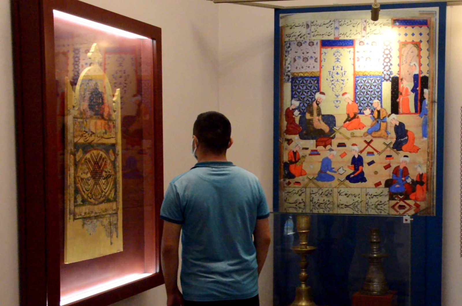 A visitor examines works in the Çifte Minareli Medrese, Erzurum, eastern Turkey, July 15, 2021. (DHA Photo)