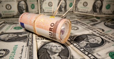 Rolled euro banknotes are placed on U.S. dollar banknotes in this illustration taken May 26, 2020. (Reuters Photo)